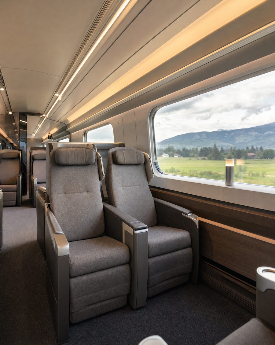 Modern reclined seating interior of a European intercity train's premium compartment